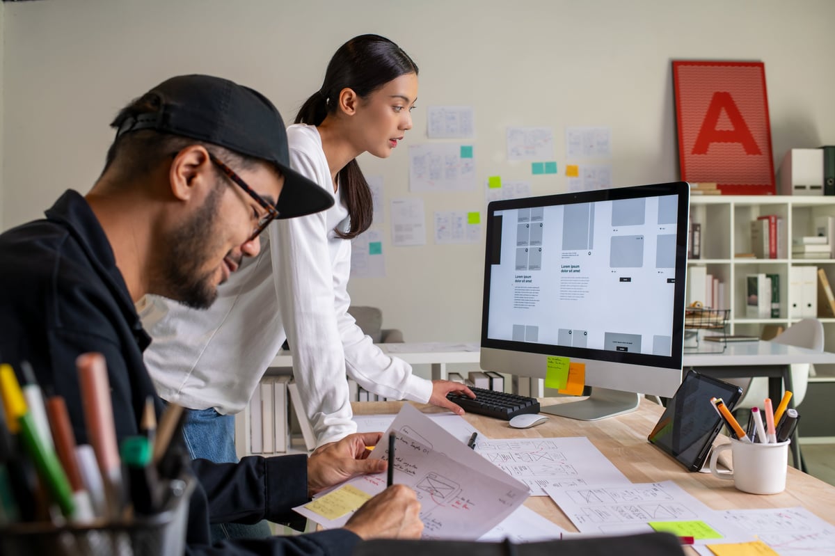 UX UI designers discussing and brainstorming on wireframes